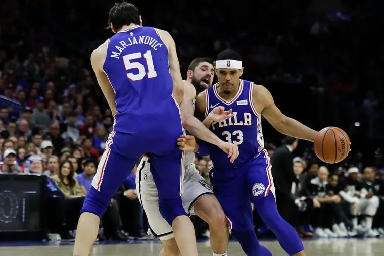 Sixers forward Tobias Harris dribbles the basketball as teammate center Boban Marjanovic sets a screen on Brooklyn Nets forward Joe Harris in game two of the Eastern Conference playoffs on Monday, April 15, 2019 in Philadelphia.