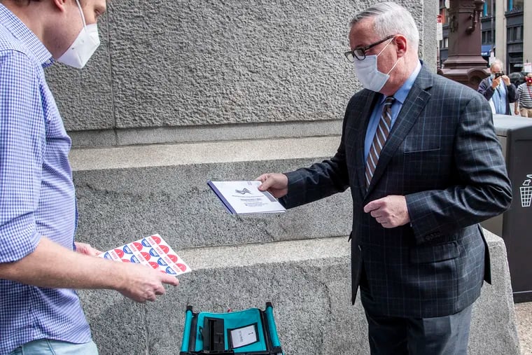 Philadelphia Mayor Jim Kenney delivers his mail ballot outside City Hall on Monday.