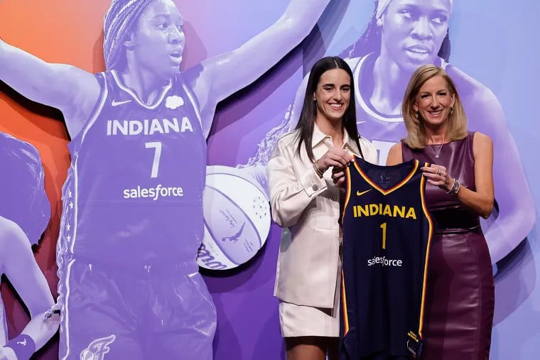 Iowa's Caitlin Clark (left) poses for a photo with WNBA commissioner Cathy Engelbert (right) after being selected first overall by the Indiana Fever.