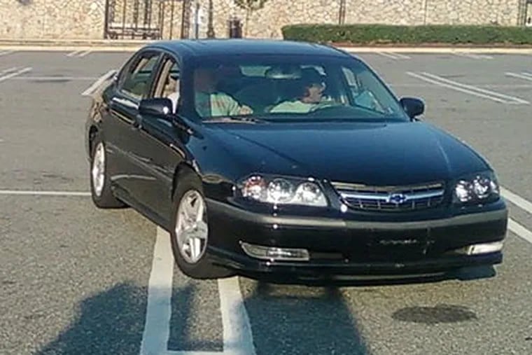 At least two workers were physically assaulted with baseball bats, but one of the victims was able to use his cell phone to photograph the suspects and their car. (Image released by Upper Merion Township police)