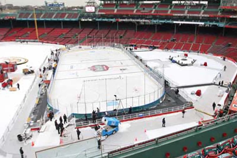 Workers prepare the ice in the infield of Fenway Park the day before
the Winter Classic. (Michael Bryant / Staff photographer)