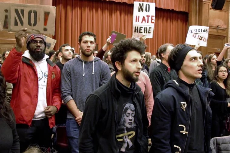Middlebury College students turn their backs to Charles Murray during his lecture there in March. A Middlebury professor was assaulted during the protests.
