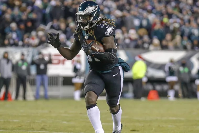 Eagles running back Jay Ajayi runs with the football against the Oakland Raiders on Monday, December 25, 2017 in Philadelphia. YONG KIM / Staff Photographer