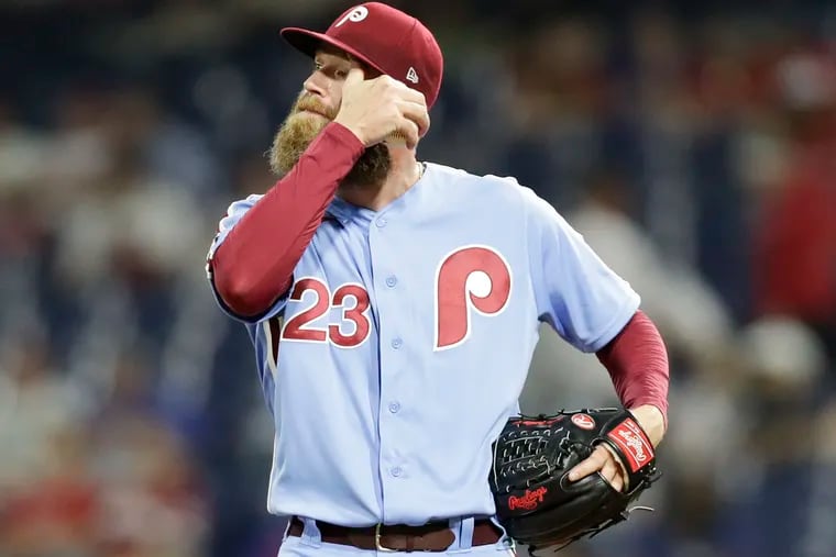Phillies pitcher Archie Bradley reacts after the Marlins' Garrett Cooper hit a sixth-inning RBI triple.