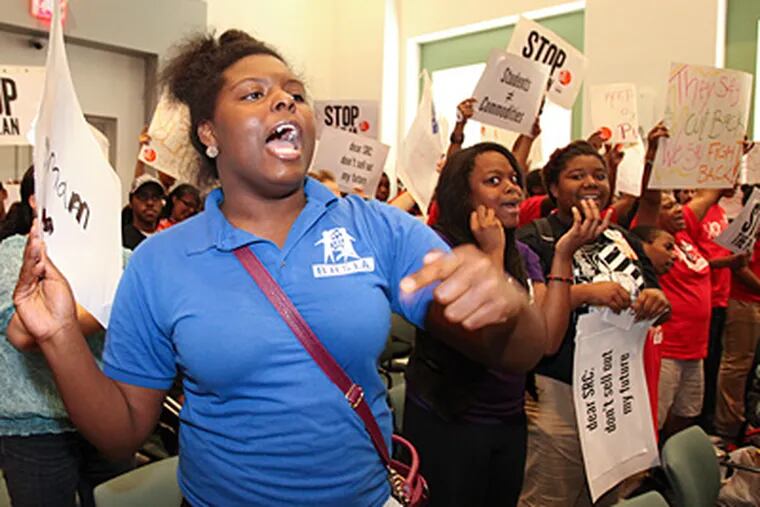 Protesters speak out during the School Reform Commission meeting at which the $2.5 billion 2012-13 budget was adopted. The spending plan will require the district to borrow $218 million to meet expenses. STEVEN M. FALK / Staff