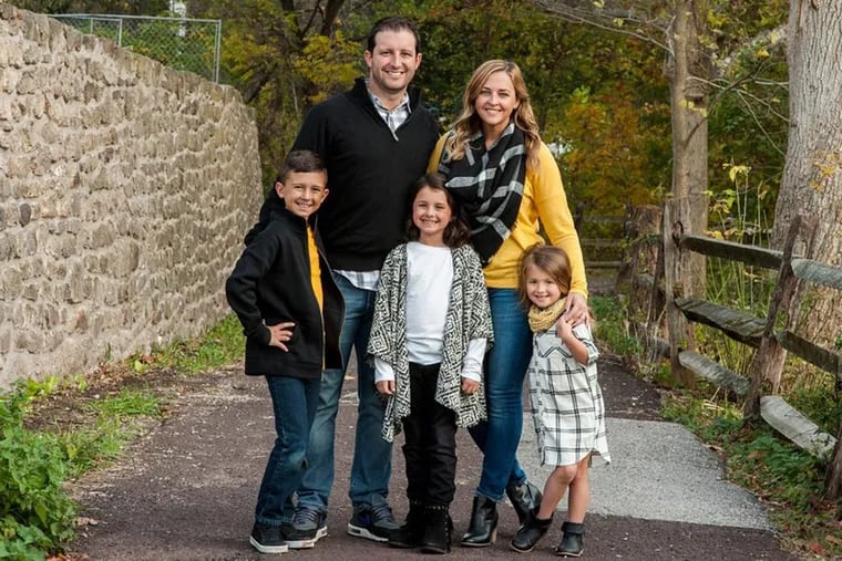 Amy Cavaliere, who survived a Spontaneous Coronary Artery Dissection, with her husband and three kids.