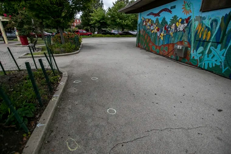 Evidence circles on pavement inside the Roberto Clemente Playground on Thursday morning at 18th and Wallace in Spring Garden section of Philadelphia, September 17, 2020. This was the scene of a Wednesday night shooting that killed two people.