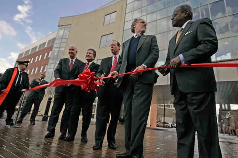 A new $37 million Rutgers University School of Law-Camden building was the site of a ribbon cutting yesterday. Due process was observed by (from left) state Assembly Speaker Joseph J. Roberts Jr., Rutgers president Richard L. McCormick, law school dean Rayman Solomon, Gov. Corzine and Camden CEO Theodore Z. Davis. It is the first major addition to the campus in decades.