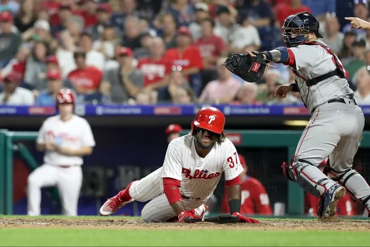 Odubel Herrera falls to the ground after striking out in the eighth inning against the Red Sox Tuesday.