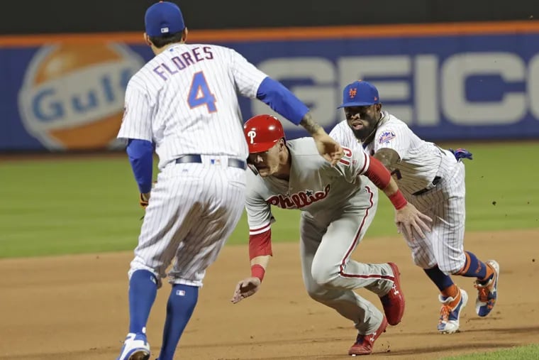 Andrew Knapp gets caught in a costly rundown in the 10th inning of the Phillies' loss to the Mets on Wednesday.