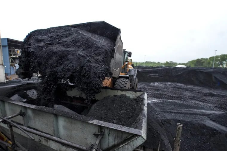 A mountain of coal is being removed from the Mercer Generation Station as part of its shut-down. CLEM MURRAY / Staff Photographer