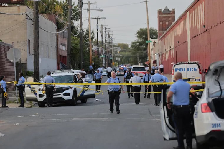 Philadelphia Police officers investigate a shooting scene near 10th Street in North Philadelphia on Oct. 7. Keith Blount confronted officers there just hours after he allegedly killed a co-worker near Philadelphia International Airport, authorities said.