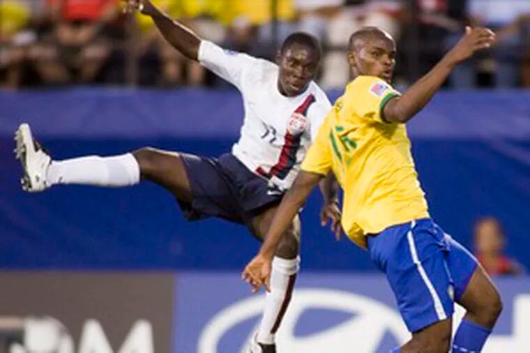 Freddy Adu (left) gets off a shot past Edson of Brazil in last week&#0039;s 2-1 American victory.