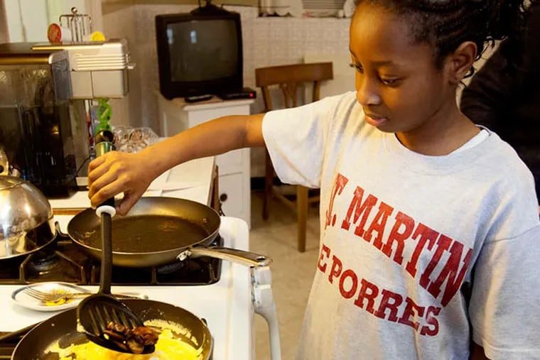 Maliyah Gregg cooks her omelet. It was egg day for the fifth- and sixth-grade budding cooks at St. Martin de Porres school in North Philadelphia.