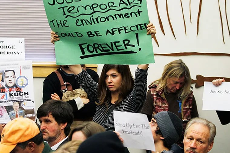 Opponents of the pipeline hold up signs before the vote.  January 10, 2014. ( MICHAEL S. WIRTZ / staff photographer )