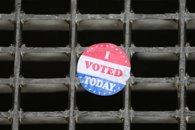 An “I voted today” sticker rests on a subway grate outside the early voting location at the Liacouras Center.