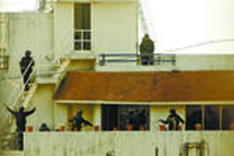 National Security Guard commandos guard the building containing the headquarters of the Mumbai Chabad house.