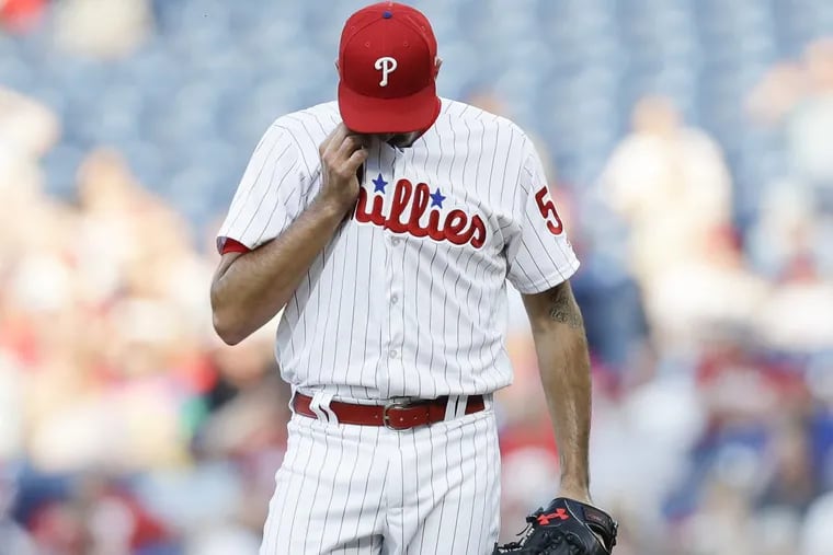 Phillies pitcher Zach Eflin wipes his face after the Toronto Blue Jays scored three runs in the first-inning on Friday, May 25, 2018 in Philadelphia.