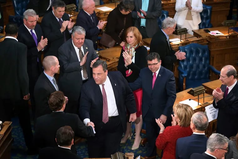 New Jersey Gov. Chris Christie, center, arrives in the Assembly chamber of the Statehouse to deliver his State Of The State address Tuesday, Jan. 10, 2017, in Trenton, N.J. (AP Photo/Mel Evans)