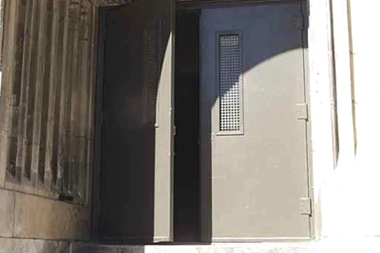 A file photo of an unsecured door at Fitzsimons High.  The school is on a new list of persistently dangerous schools. (Inquirer)