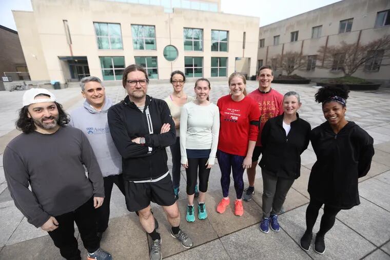 Kyle Cassidy (middle in black) and other members of The Annenberg Running Club meet three times a week at the plaza at 36th and Locust.