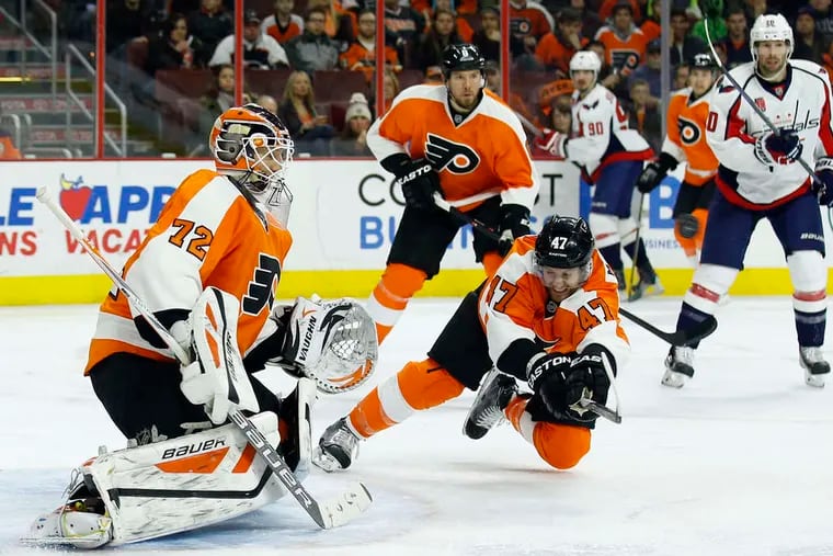 Defenseman Andrew MacDonald, shown diving to deflect a puck, and the Flyers are parting ways after parts of six seasons.