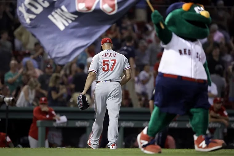 Pitcher Luis Garcia leaves the field after giving up a walk-off ground-rule double to Boston's Blake Swihart Monday at Fenway Park. The Phillies lost to the Red Sox, 2-1, after 13 innings.