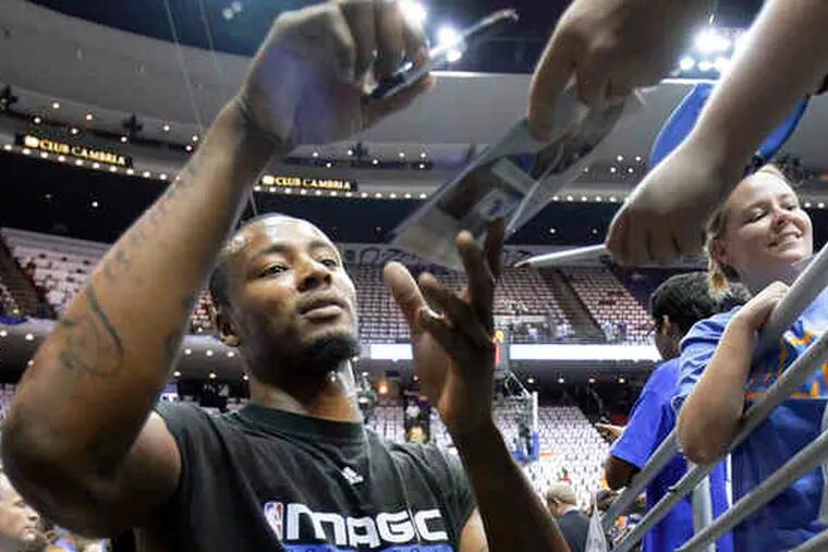 Orlando's Rashard Lewis signs autographs before last night's Game 4 of the NBA Finals.