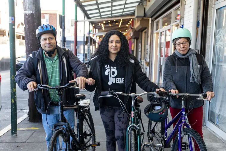 (From left to right) Martin Franco, dad, Sarahi Franco-Morales, 17, of South Philadelphia, Pa., daughter, and Dora Morales, mom, pose for a portrait in Philadelphia, Pa., on Wednesday, Feb. 1, 2023. The three of them commute everywhere by bike.