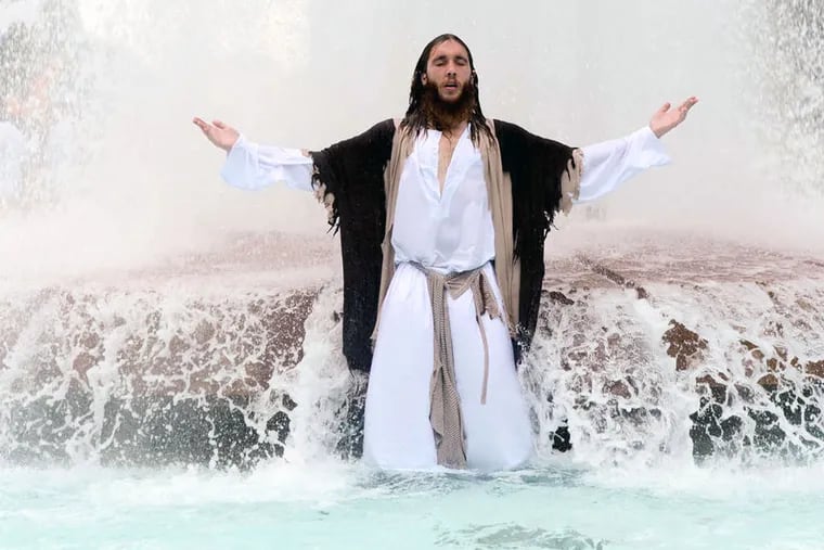 Philly Jesus enters the LOVE Park fountain.