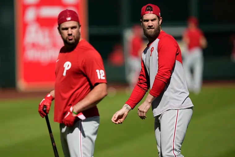 Bryce Harper's return means Kyle Schwarber (left) will move back to left field and out of the No. 3 spot in the lineup.