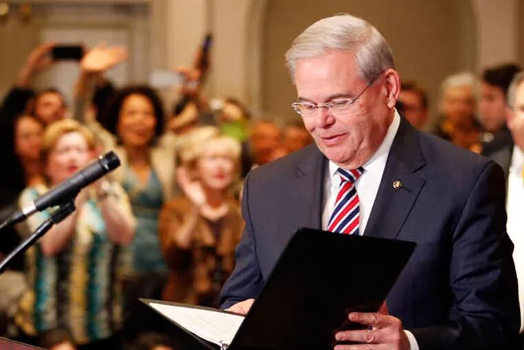 Supporters cheer Sen. Robert Menendez (D., N.J.), who pleaded not guilty to corruption charges in federal court Thursday. Menendez is accused of using his office to improperly benefit an eye doctor and political donor in return for gifts. (JULIO CORTEZ / Associated Press)