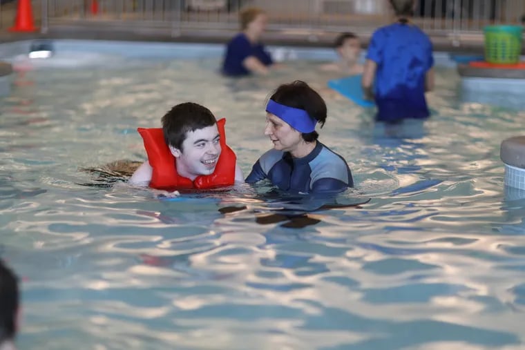 Swimming teacher Sylvie Moran works with Patch Burke at the Bancroft School, in Mt. Laurel,which has a therapeutic pool on campus and has partnered with the local YMCA to provide swim lessons to all the students with autism or other intellectual disabilities.