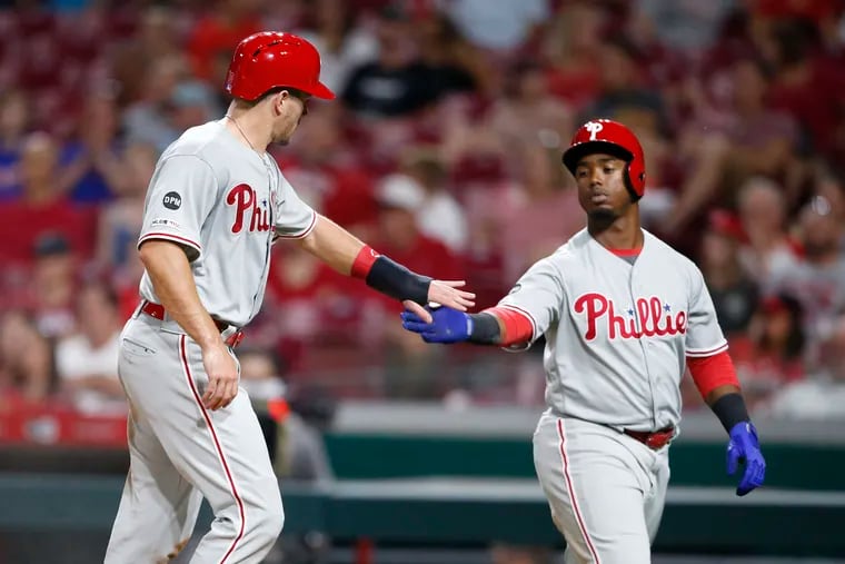 Jean Segura, right, congratulates J.T. Realmuto on scoring a fifth-inning run Tuesday night in the Phillies' 6-2 victory over the Cincinnati Reds at Great American Ball Park.