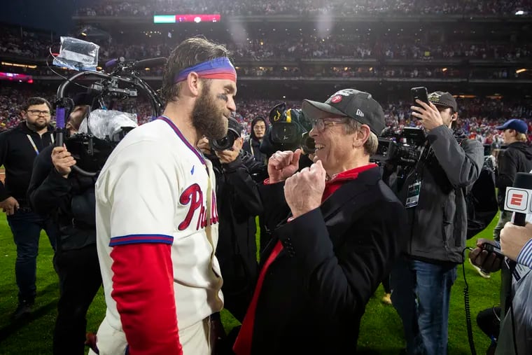 Bryce Harper (left) and Phillies managing partner John Middleton celebrated together on the field at Citizens Bank Park after the team won the pennant in 2022.