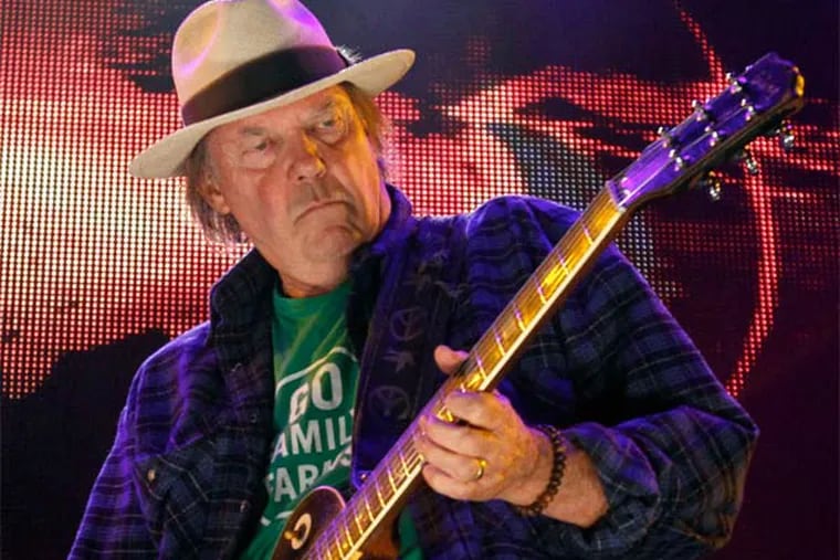 Neil Young, shown at a previous show, had plenty of guitars to choose from onstage at the Academy of Music. He delivered fiery performances of his classic songs and newer ones, too, but later, his rambling and song selection tripped him up.