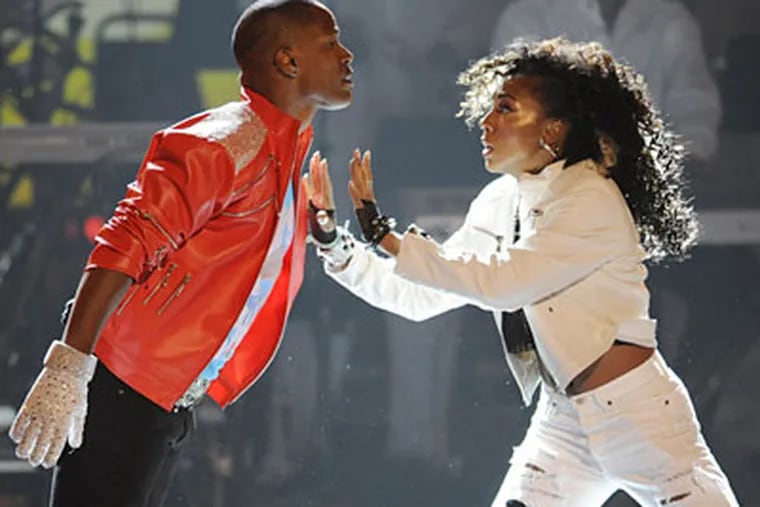Jamie Foxx and a dancer in a homage to Michael Jackson at the BET Awards. Foxx, the host, offered a monologue wearing the red leather zipper jacket and glove in the Jackson style. (CHRIS PIZZELLO / AP)