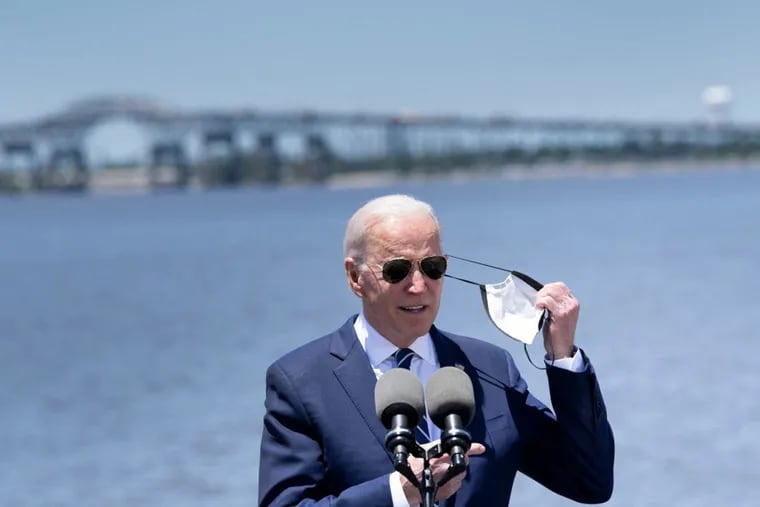 President Joe Biden takes off his mask before speaking about infrastructure and jobs along the banks of the Calcasieu River in Westlake, La., last month.