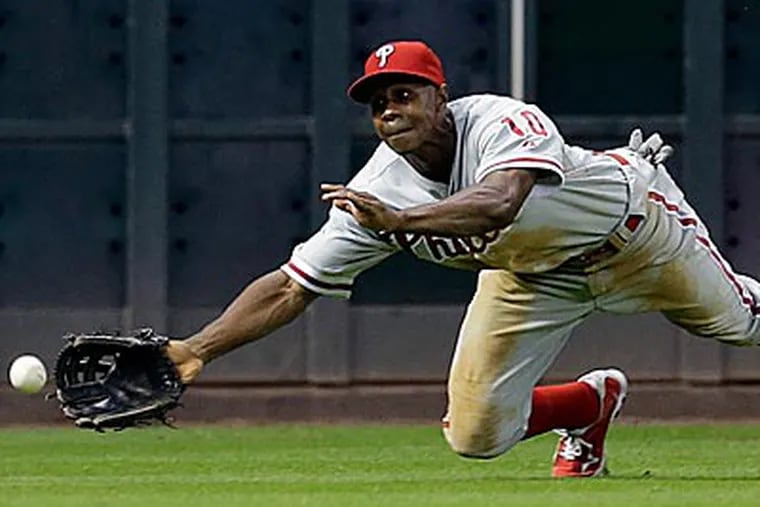 Juan Pierre can't reach a ball hit by Tyler Greene during the fourth inning. (David J. Phillip/AP)