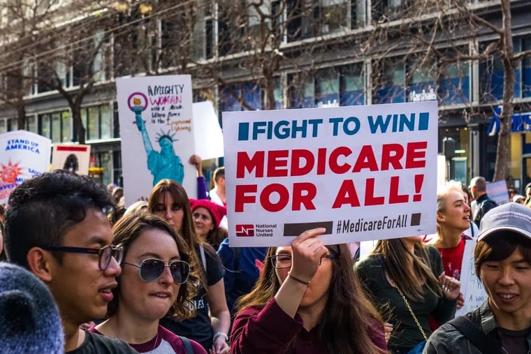 A marcher at the Women's March holds a "Medicare for All" sign  on Market street in downtown San Francisco. (Dreamstime/TNS)