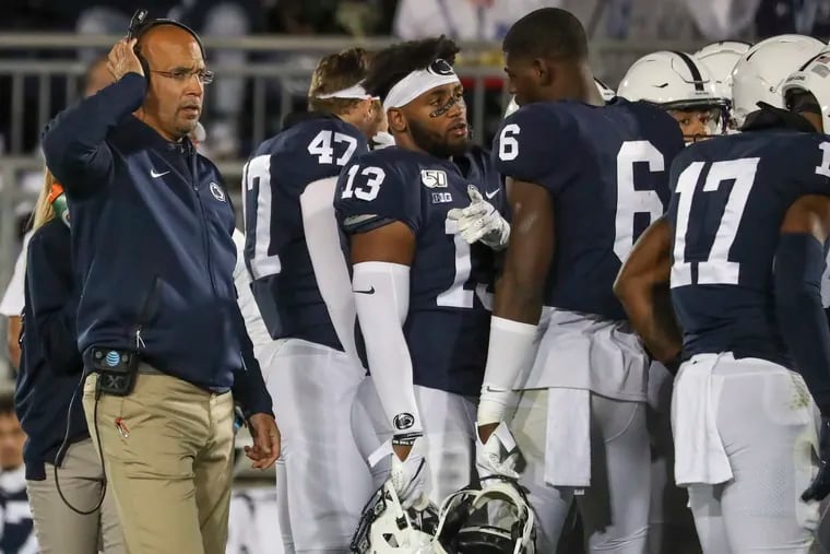 Penn State head coach James Franklin (left) with his team in 2019. The coach has lots of extra challenges this season.