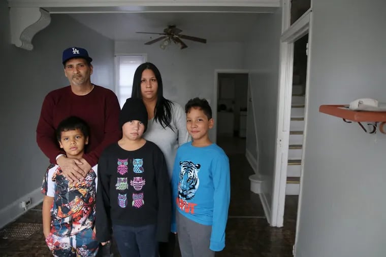 Jesús Rodriguez, top left, and his wife, Sandra Martínez, stand for a portrait with sons Yadiel, 7, Kristal, 10, and Yandel, 12, at their home in the Fairhill neighborhood of Philadelphia on Tuesday, Feb. 6, 2018. The family left Puerto Rico for Philadelphia in November, but now faces an uncertain future as their cash reserves have run out and they struggle to find work. They have no living room furniture because they cannot afford it.
