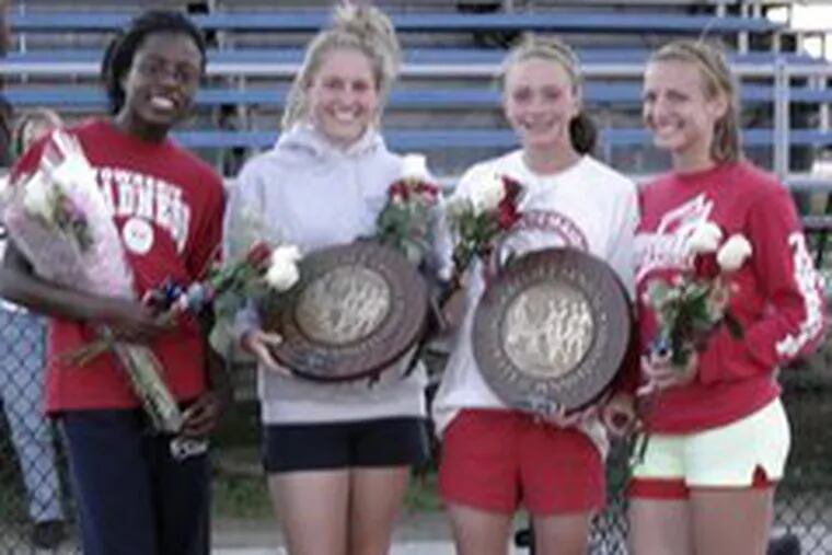 Washington Township High School sprinters (from left) Jackie Dim, Lauren Wilcox, Kim Kraus and Michelle Martin gather with the two plaques they won as South Jersey large-school and Philadelphia-area champions in the 4 x 400-meter relay at the Penn Relays at Franklin Field.