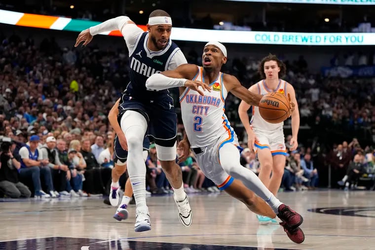 Shai Gilgeous-Alexander #2 of the Oklahoma City Thunder is defended by Daniel Gafford #21 of the Dallas Mavericks during the first half at American Airlines Center on February 10, 2024 in Dallas, Texas.