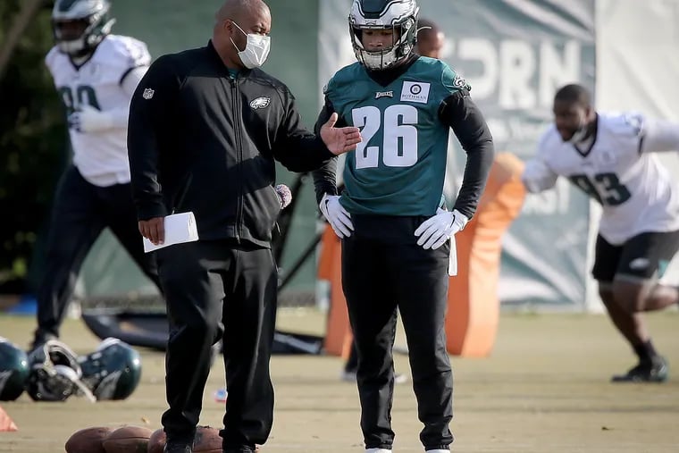 Duce Staley confers with Miles Sanders during a November practice.