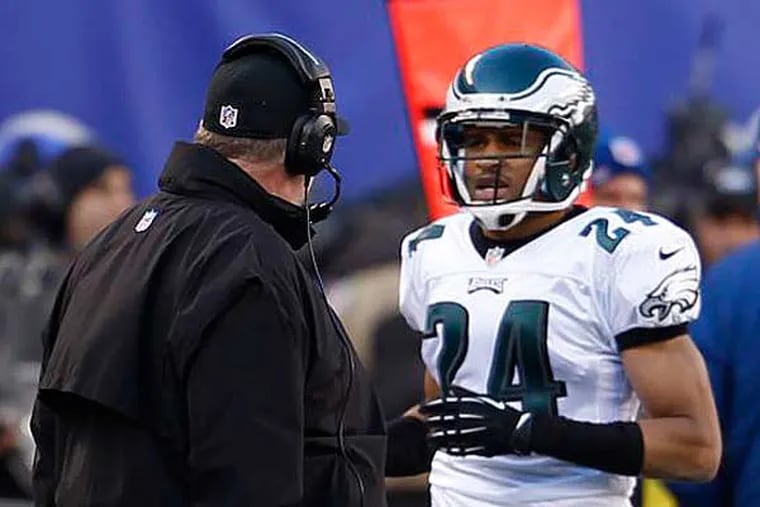Nnamdi Asomugha talks with Andy Reid after he and other Eagles got beat by Victor Cruz for a TD. (Ron Cortes/Staff Photographer)
