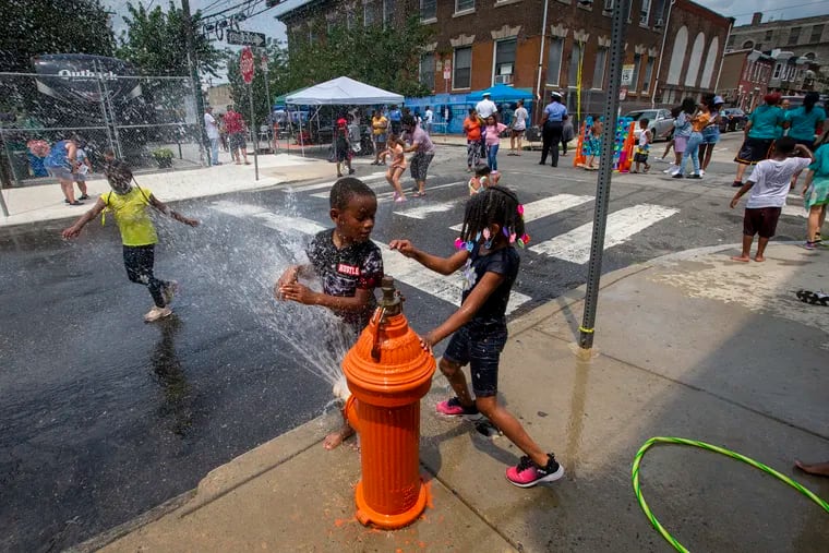 Children enjoy the cool refreshing water from a fire hydrant at N. Howard and Somerset during a Philadelphia Police Block Party. Philadelphia Police, 25th District host a block party along N. Front from Lehigh to Somerset then west to Howard on Thursday, July 15, 2021. This is the 5th year the police have put on this event. Last year it was cancelled. The event was first started by Inspector Michael Cram to disrupt drug sales and now its used to reach out to children with fun games and adults in East Division with services and organizations like the Army, Temple, Esperanza, etc.