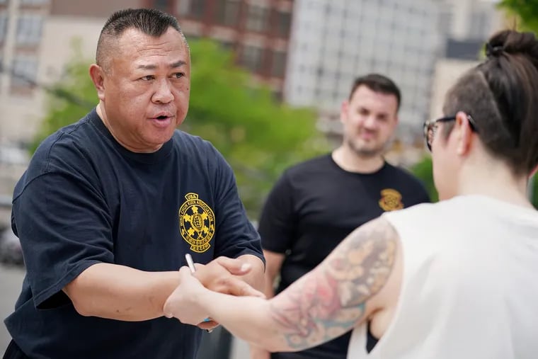 Grandmaster Art Eng (left), owner of Philadelphia Wing Chun Kung Fu, practices a wrist grab escape with Tanya Agullo during one of the Philly Fighting Asian Hate self-defense classes at the Rail Park in Philadelphia on Saturday, May 22, 2021. About 150 people registered to attend one of six free self-defense classes on Saturday and Sunday, organized by several community organizations and taught by members of the Philadelphia Wing Chun Kung Fu school, in response to a nationwide spate of anti-Asian attacks.