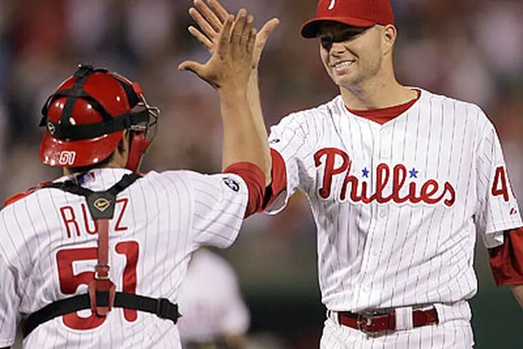 Ryan Madson and Carlos Ruiz celebrate after closing out the Phillies' win. (Yong Kim/Staff Photographer)