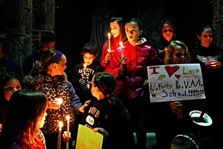 At Nativity of the Blessed Virgin Mary in Media, the news was not good. Students held a candlelight vigil Friday night after learning that their school, which was expected to be the site of a regional school, will instead close. (Laurence Kesterson / Staff Photographer)